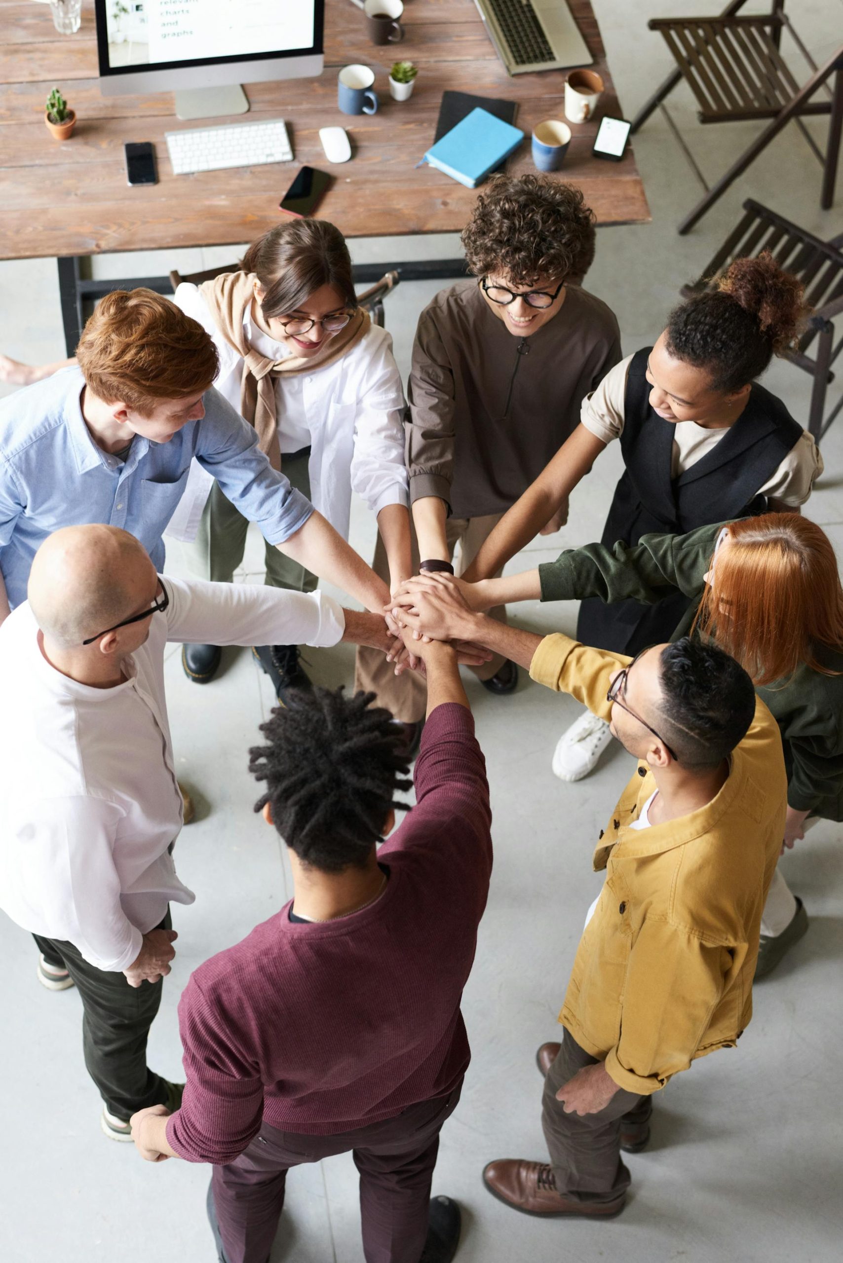 Team celebrating with hands in the middle